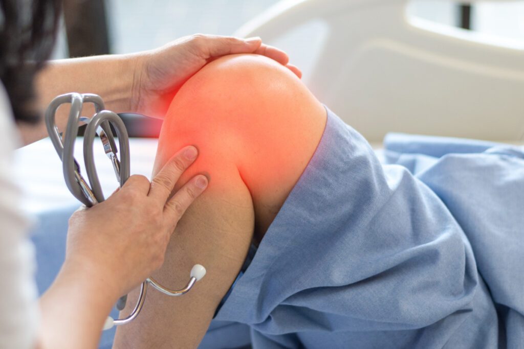 A doctor pinpointing the location of a patient's knee pain.